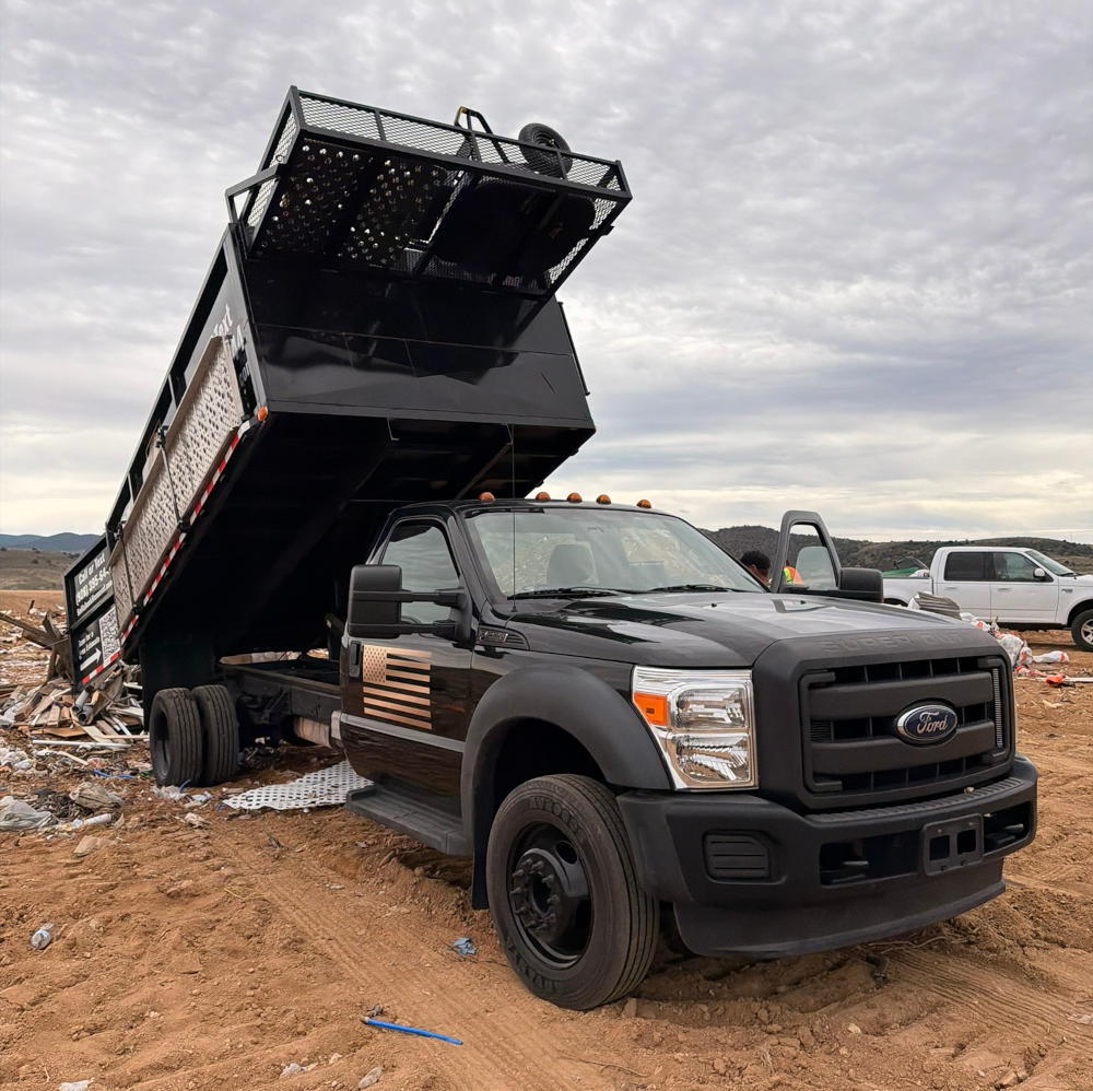 Bella Junk Removal dump truck unloading debris at Grey Wolf Landfill during junk removal services in the Verde Valley, AZ.