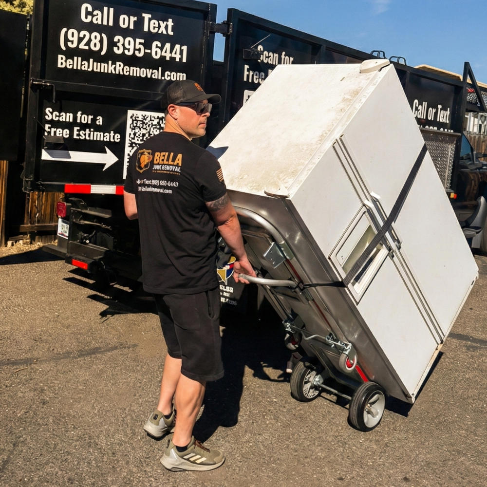 The Bella Junk Removal Team doing an appliance removal using a hand truck.